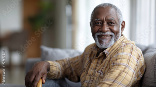 Happy senior man smiling and relaxing on sofa at home