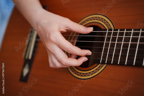 Fotografía Person playing guitar with right hand while touching strings