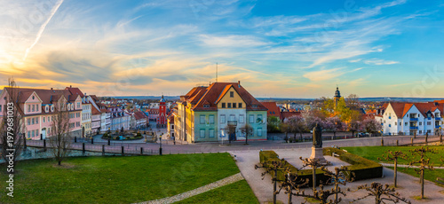 Panoramic view over Gotha with historic city center, market square, monument and colorful houses, wide green foreground and dramatic evening sky showing urban heritage in Thuringia, Germany