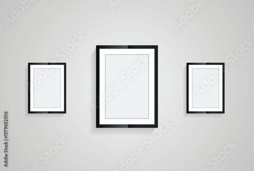Three picture frames with black blank hanging on the whitewall for mock up design, vector black photo frames in diferent sizes of wooden Frames Hanging on the wall