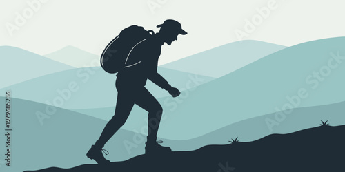 Silhouette of a male hiker with a large backpack trekking up a hill against a background of misty blue mountain ranges at dawn silhouette mountain backpack trekking adventure climbing