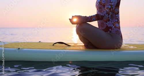 Young woman walking on sup board by the sea during summer vacation. Slow motion