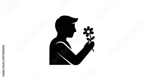 Silhouette of man holding flower.