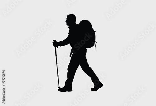 A black silhouette of a person hiking with a heavy backpack walking across a plain surface path.