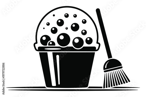 Black and white of a bucket full of suds and a broom, symbolizing cleaning