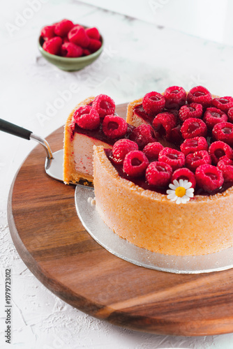 Raspberry Cake With Slice On Wooden Board