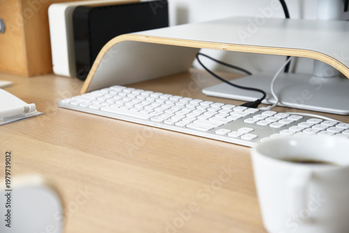 Keyboard on wooden desk in minimal workspace close up