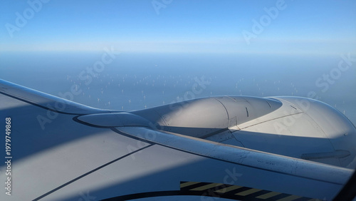 Airplane Wing Above the windmills field Clouds View
