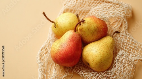 Fresh pears and one red fruit in a white mesh shopping bag, representing sustainable living and choices food healthy natural
