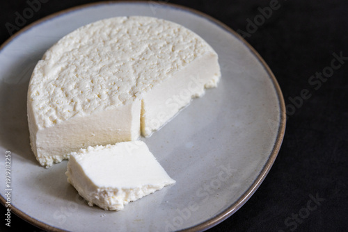 Queso blanco on a gray ceramic plate dark backdrop