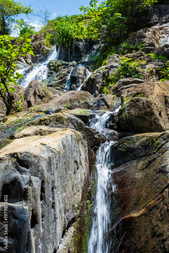Rocky waterfall in a forested hillside near Fort Portal