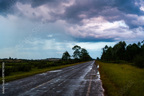 Tableau sur toile Wet rural road under storm clouds near Mbarara in western Uganda