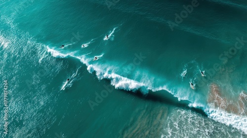 Aerial View of Surfers Riding Waves in Turquoise Ocean Water