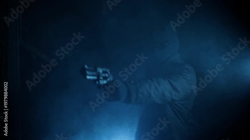 Hooded Gunman Aiming Weapon in Dark Fog, Crime and Danger Concept