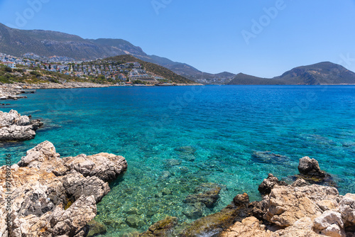 Wild beach of Kalkan. Landscape photo. Turquoise waters lap a rugged rocky co...