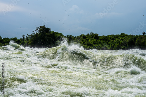 Whitewater rapids on the Nile near Jinja under a cloudy sky