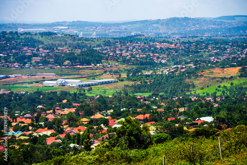 Elevated view of suburban neighborhoods and green hills near Kampala
