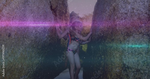 Vertical video: Three kids entering crevice feeling walls moving to opening for travel purple flare