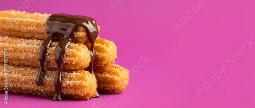 Churros with some chocolate glaze isolated against magenta background with copy space