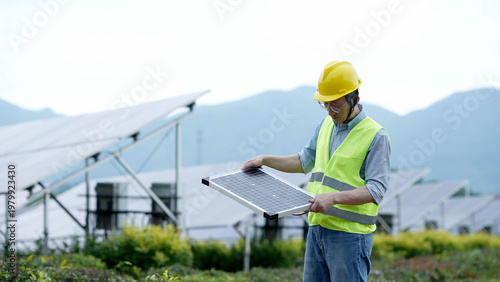 Valokuva Engineer inspecting a solar photovoltaic panel on-site in a rural mountainous ar