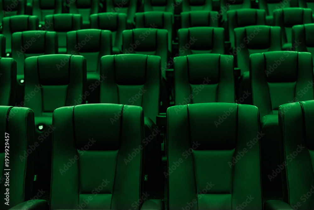 Fototapeta premium Rows of empty green cinema seats in modern movie theater