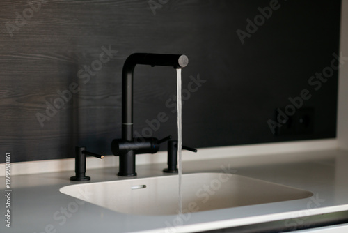 Modern kitchen sink with running water