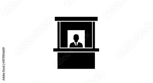 Silhouette of a person standing behind a counter in a booth or kiosk.