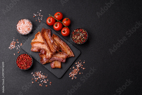 Fried fresh bacon slices with layers of meat or prosciutto prepared for breakfast. Fried bacon