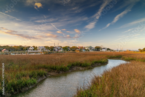 view of the boardwalk and salt marsh at Shem Creek in warm morning light