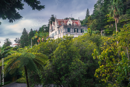 Luxury villa surrounded by lush tropical greenery in Tropical Garden Monte Palace, Madeira, Portugal.