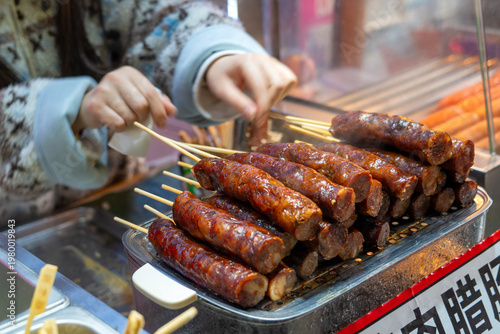 Popular Asian street food stall in Chongqing, featuring various skewered ingredients meat,chinese sausage,, China
