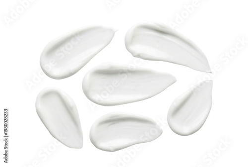 Fotografie White cosmetic cream smears top view isolated