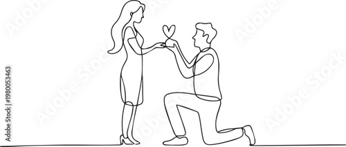 Man proposing to woman with heart shaped gift on one knee in love