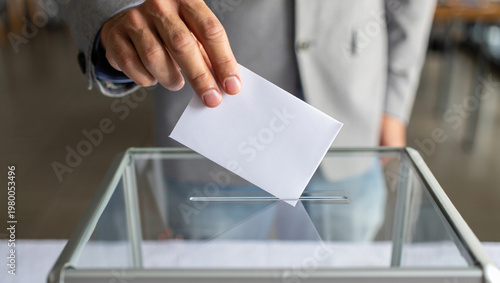 Anonymous Person Casting Blank Ballot into Transparent Box in Slow Motion