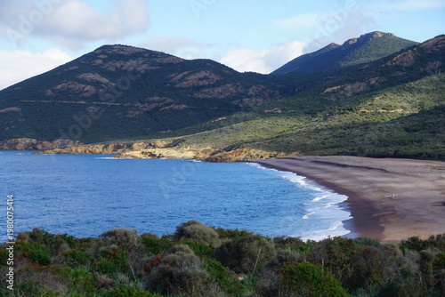 panoramic view of the beach and the mountains on the island of corsica, france near galeria