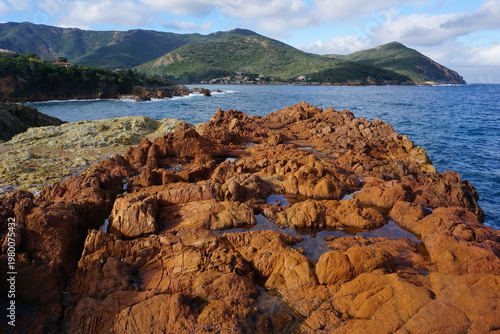 panoramic view of the beach and the mountains on the island of corsica, france near galeria