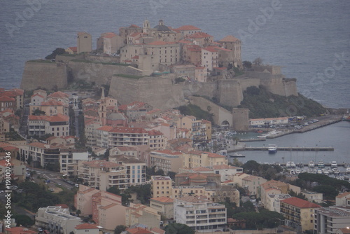 view of the coast of the mediterranean sea by the town of calvi, corsica, france
