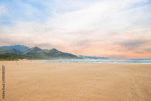 Visitors enjoying a sunny day at Cannon Beach, Oregon.