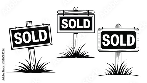 Set of wooden sold real estate signs with grass