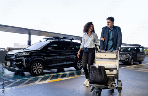 Couple arriving at airport with luggage and car service waiting