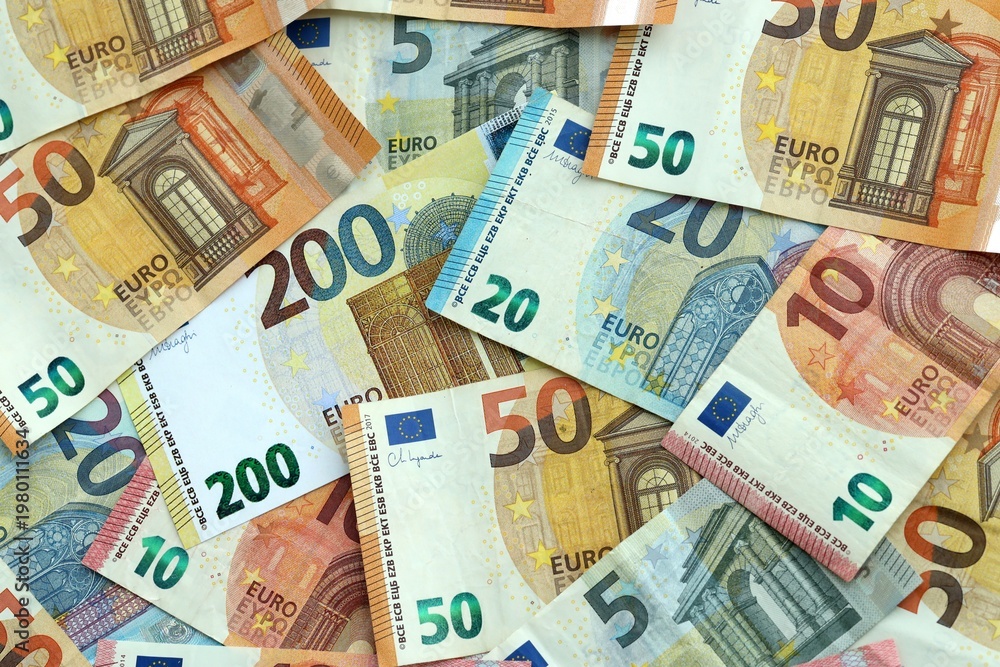 Fototapeta premium Euro money banknotes pile on table. Eurozone bills of EUR currency close up. Concept of economy
