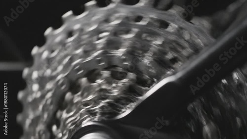 Mechanical Precision: Close-up detail of a bicycle gear set in motion, showcasing the intricate engineering and smooth operation of its components.