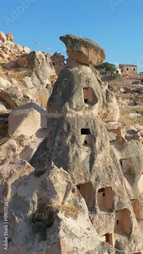 Cappadocia, Uchisar Fortress and the surrounding town, aerial view in sunny weather at sunset.	