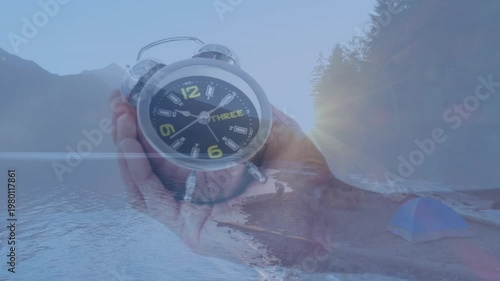 Friends camp and enjoy a lakeside night in a forest, captured in a 4k video.