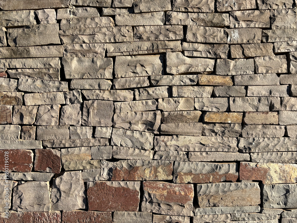 Obraz premium Natural stacked stone wall texture, rustic rock background with detailed surface