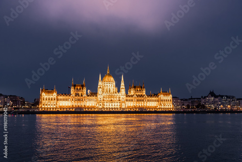 Light halo above Parliament building illuminated by spotlights in Budapest in Hungary