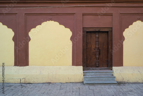 Decorative stone carved Arches, Windows & Wooden Door of fort wall of Rajwada, Indore, Madhya Pradesh. Also known as the Holkar Palace or Old Palace. Indian Architecture.