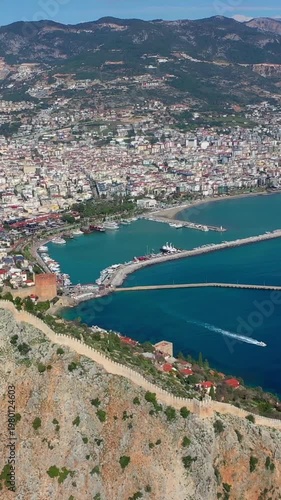 Aerial view of Red Tower (Kizil Kule), Alanya Marina and Mediterranean coast, Türkiye. Taken with a drone.