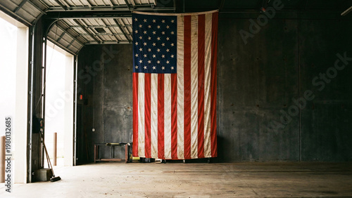 Large American Flag on Fire Station Wall With Dark Concrete Bay and Text Space, Patriotic Emergency Service Background, Realistic Fabric Detail