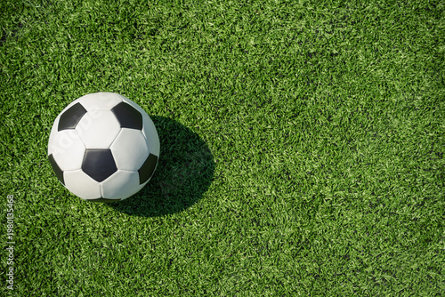 Top view soccer ball on green grass minimal sport background